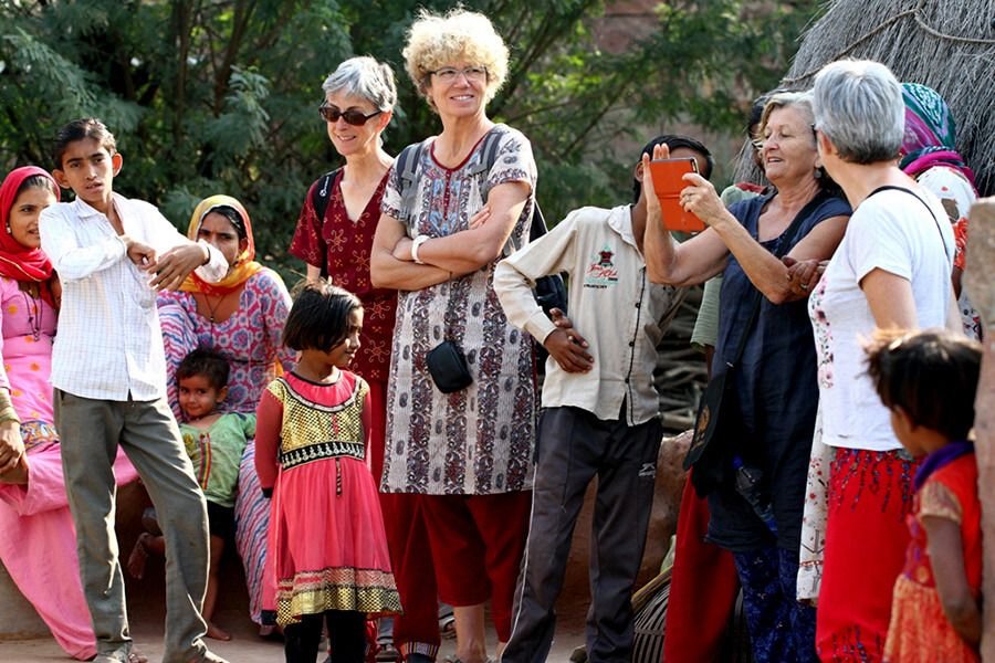 A shared moment with local families Group of visitors with local children in a Bishnoi village