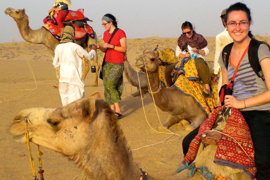 Guests with camels on the sand dunes during a desert camel safari near Osian
