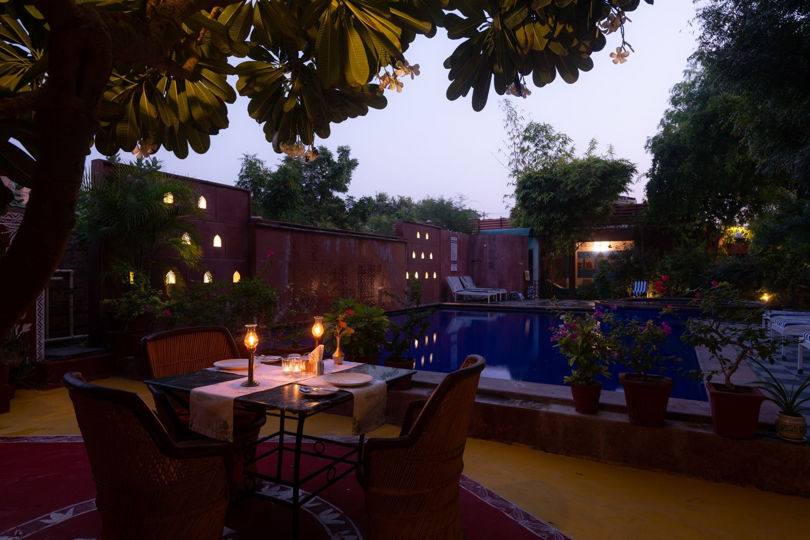 Candlelit dinner table by the pool at The Mandore, Jodhpur