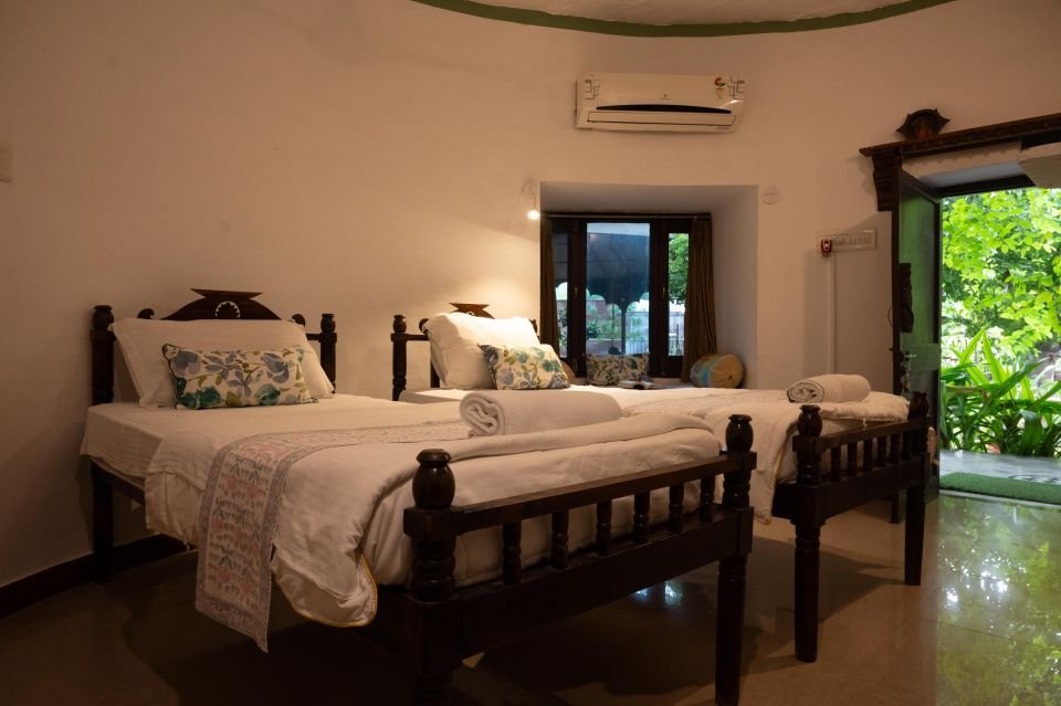 Twin beds with a door opening onto the garden Garden Room with twin beds and door opening to the garden at The Mandore, Jodhpur