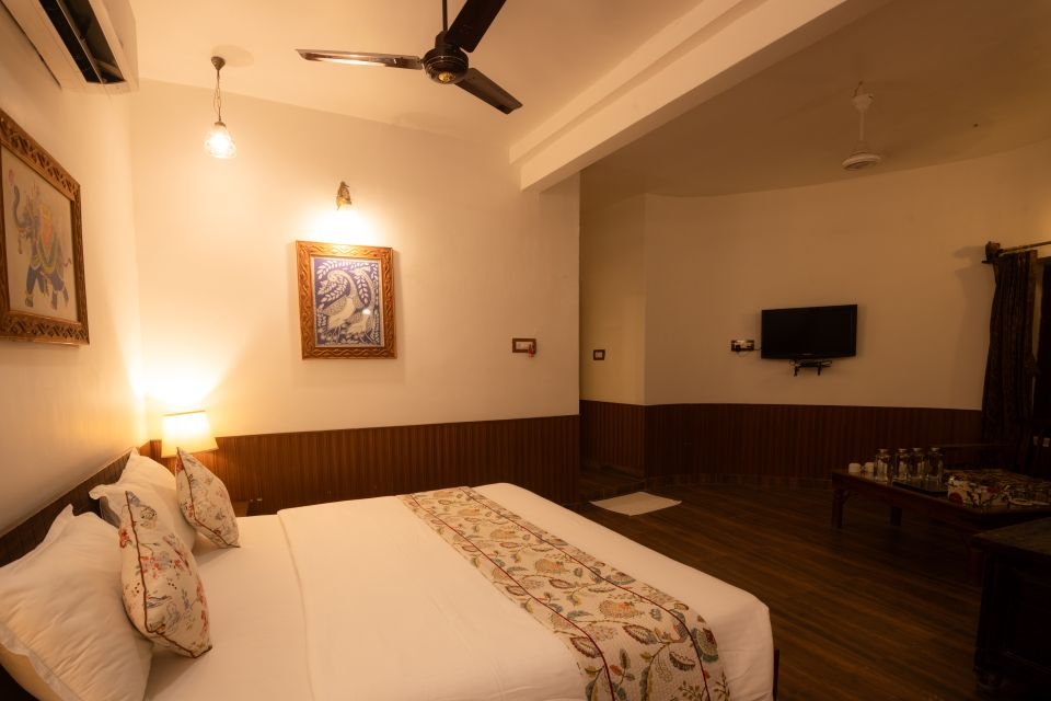 Mandore Family Room with bed, TV and seating area at The Mandore, Jodhpur