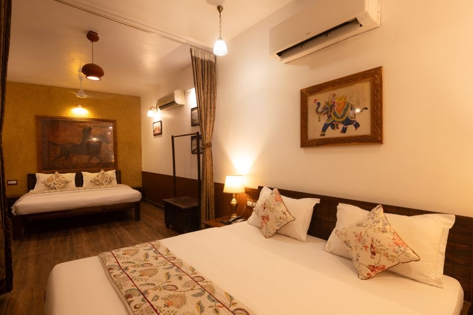 Mandore Family Room with king bed and additional bed in an alcove at The Mandore, Jodhpur