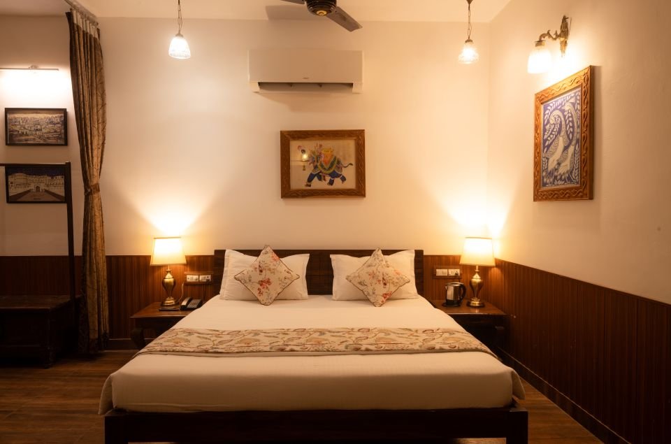 Mandore Family Room with wooden panelling and twin bedside lamps, Jodhpur