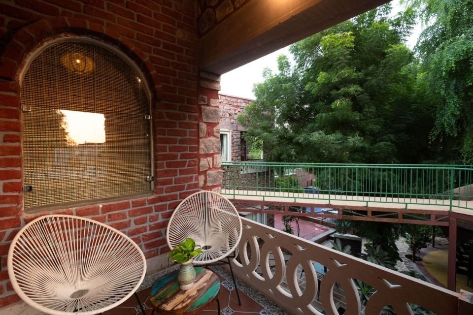 Balcony overlooking the trees Mandore Premium balcony with chairs overlooking the trees at The Mandore, Jodhpur