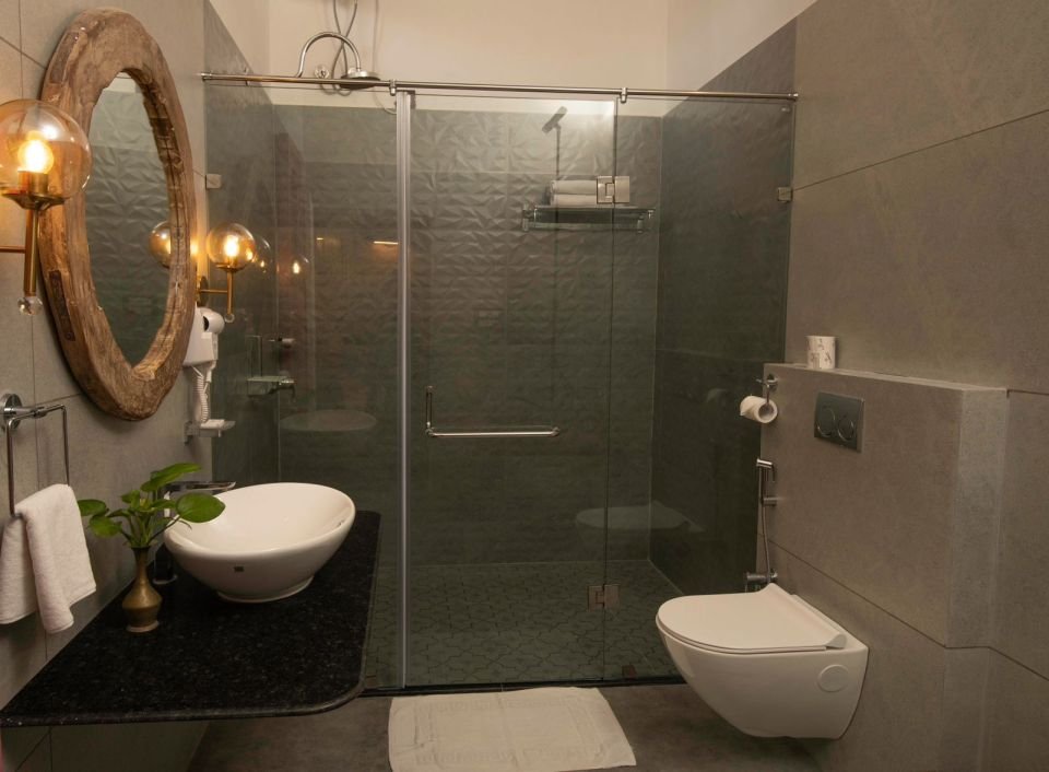 Rain shower and vessel basin Mandore Premium bathroom with rain shower, vessel basin and round mirror at The Mandore, Jodhpur