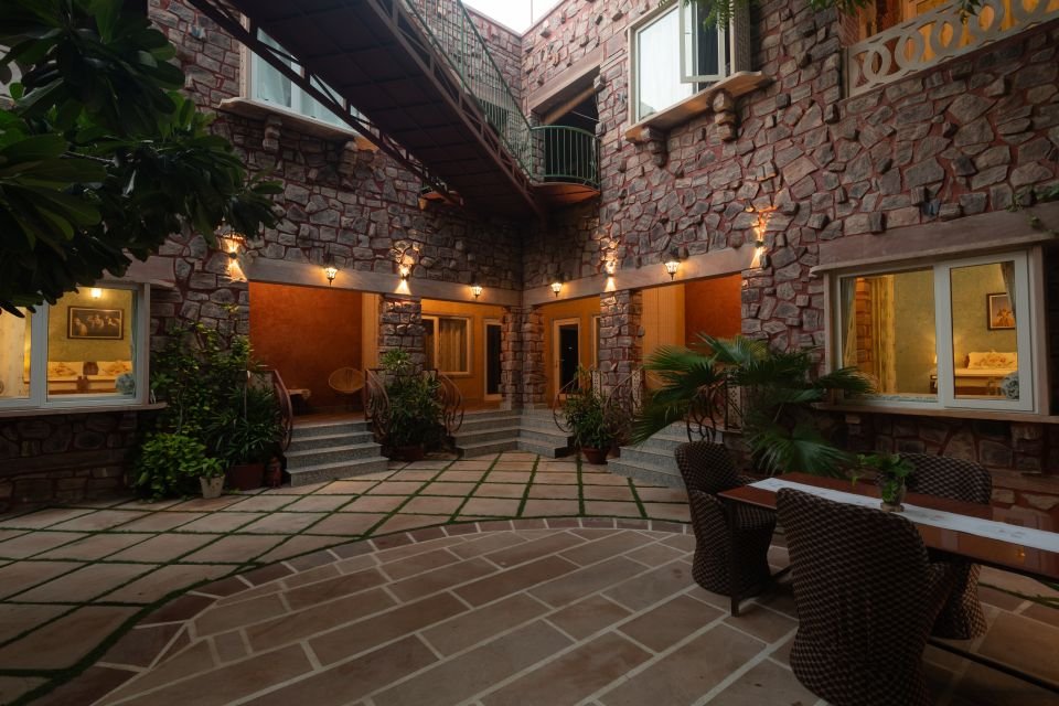 Lantern-lit courtyard Stone courtyard with lanterns and seating outside the Mandore Premium rooms, Jodhpur