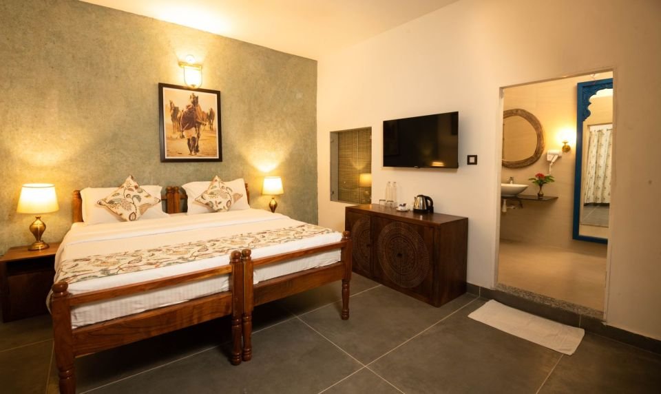 King bed with hand-picked artwork Mandore Premium king bed with artwork and TV at The Mandore, Jodhpur