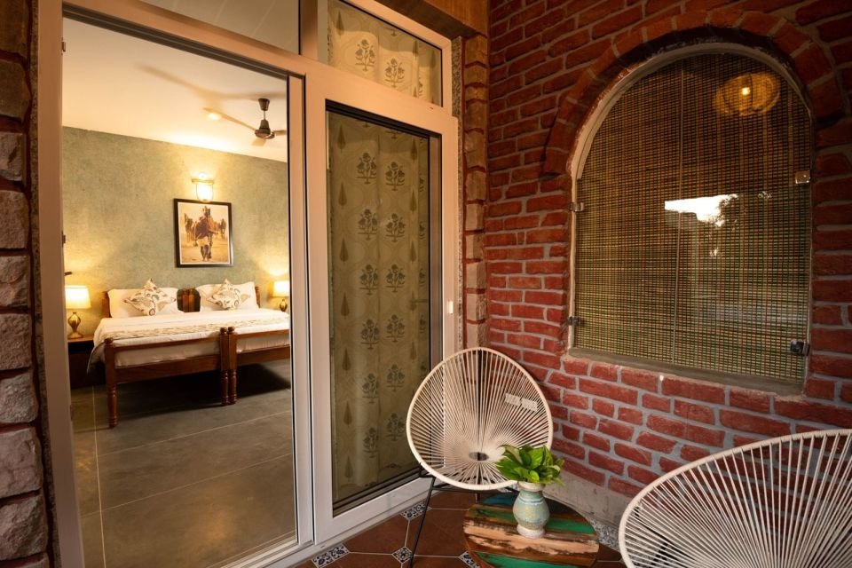 Private balcony Mandore Suite balcony with chairs and view into the bedroom at The Mandore, Jodhpur