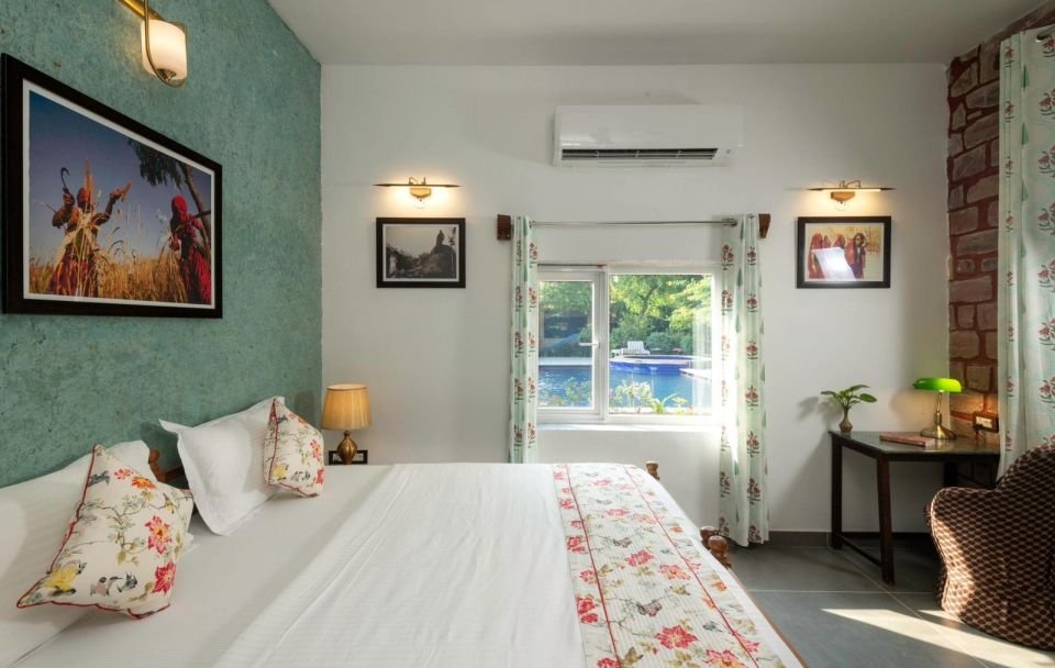 Bright bedroom with large windows Mandore Suite king bed beside a large window at The Mandore, Jodhpur