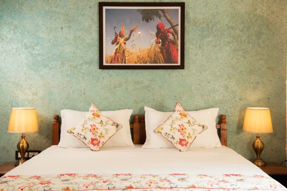 King bed with floral linen Mandore Suite king bed with floral linen and bedside lamps at The Mandore, Jodhpur